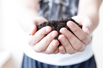 Man farmer holding soil. Earth day and ecology concept