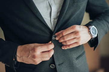 Morning gathering of the groom at home. The groom in black blues