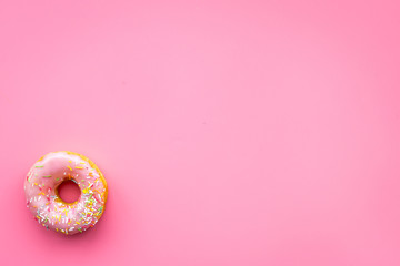 Sweet tasty snack. Glazed donut on pink background top view copy space