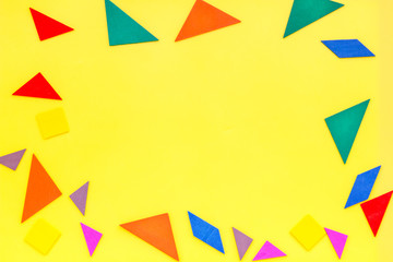 pieces of bright paper for puzzle on yellow office background top view mockup