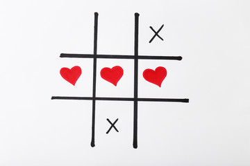 Tic tac toe game by hearts on white background