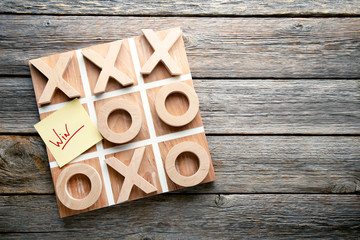 Wooden tic tac toe game on grey table