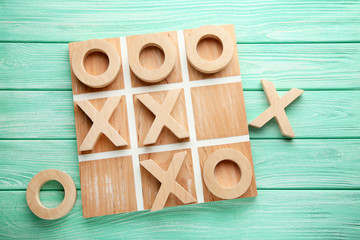 Wooden tic tac toe game on mint table