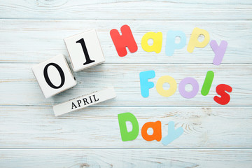 Calendar cubes with inscription Happy Fools Day on wooden table