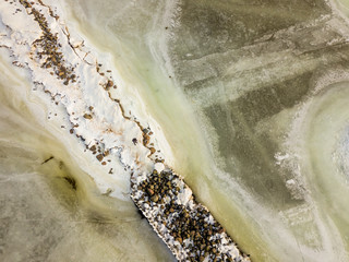 Aerial Photography of Snowy Beach With  Winter Jetty Covered in Ice