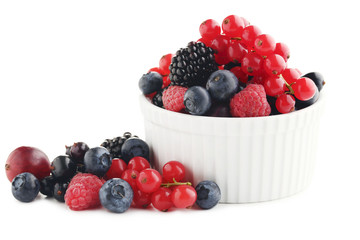 Ripe and sweet berries in bowl on white background