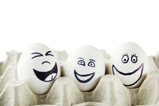 Eggs with funny faces in carton package