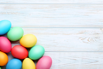 Colorful easter eggs on white wooden table