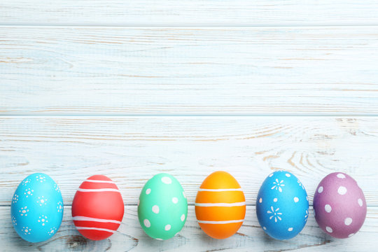 Colorful easter eggs on wooden table