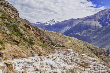 Salt Pools harvested for salt fed by a small stream by local families high in the Andes at Maras, Peru