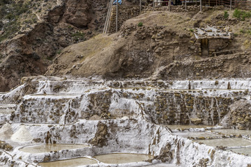 Fototapeta premium Salt Pools harvested for salt fed by a small stream by local families high in the Andes at Maras, Peru