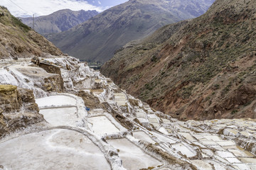 Salt Pools harvested for salt fed by a small stream by local families high in the Andes at Maras, Peru