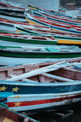 Fototapeta na wymiar Multicolored local fishing boats waiting on the coast of good weather. Ponta do Sol Santo Antao Cape Verde
