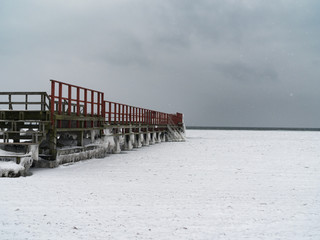 Helgoland Copenhagens bridge with red rails sorrounded by ice and snow durring winter