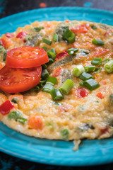 Omelet, fried chicken eggs with fresh vegetables