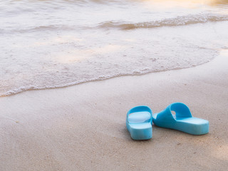 Fototapeta na wymiar Flip flops , on a sandy ocean beach.