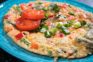 Omelet, fried chicken eggs with fresh vegetables