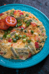 Omelet, fried chicken eggs with fresh vegetables