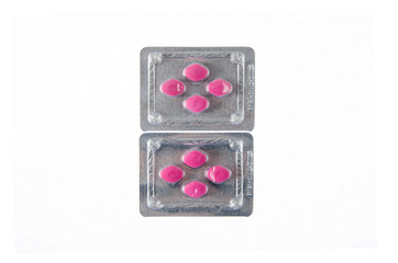 two plates of red pills on white isolated background