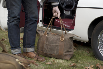 Man picking up luggage