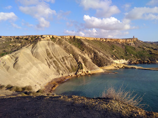 Fototapeta na wymiar Comino island blue lagoon. Malta blue turquoise sea water beach. Rock and cliff sunny seashore. Travel mediterranean.