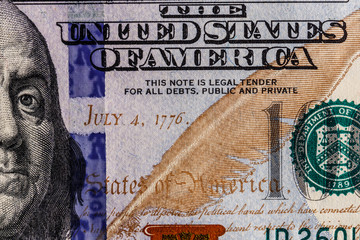 Closeup of Ben Franklin and the date of independence July 4, 1776 on a one hundred dollar bill for...