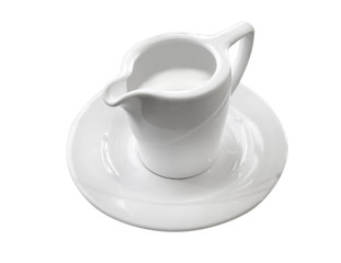 coffee creamer on a saucer on an empty white background. Mini pitcher full of milk,