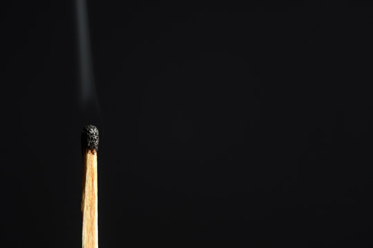 Match with the burned head on a black background closeup