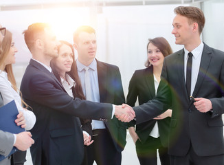 business team looks at the handshake business partners