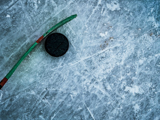 hockey puck and stick on the ice texture, copyspace and text