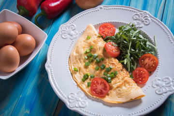 Omelet, fried chicken eggs with fresh vegetables