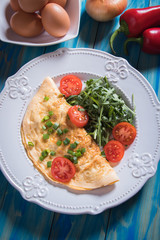 Omelet, fried chicken eggs with fresh vegetables