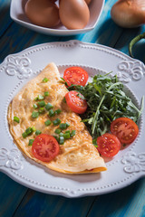 Omelet, fried chicken eggs with fresh vegetables