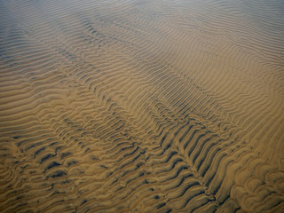 stripes of sand and color underneath the surface