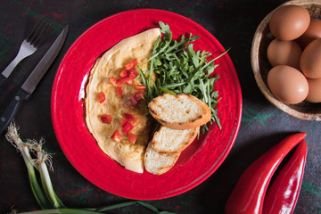 Omelet, fried chicken eggs with fresh vegetables