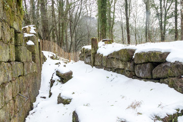 Old ruined watermill covered with snow winter 2018