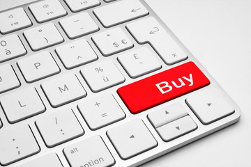 Red Buy button on a white keyboard isolated on a white background