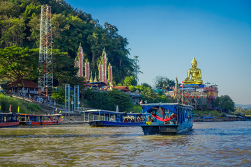 Outdoor view of a group of tourists in a tourist boat visiting the golden budha located at golden...