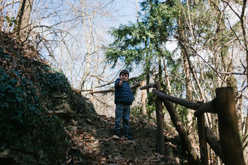 child walks on a path in the woods