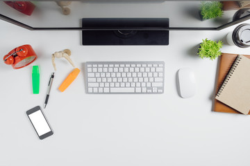 Modern White office desk table with computer,smart phone,notebook and cup of coffee.Top view with copy space.Working desk table concept.
