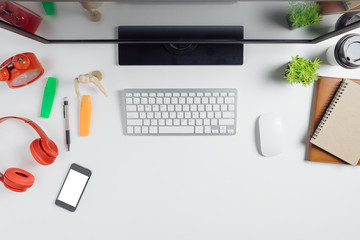 Modern White office desk table with computer,smart phone,notebook and cup of coffee.Top view with copy space.Working desk table concept.