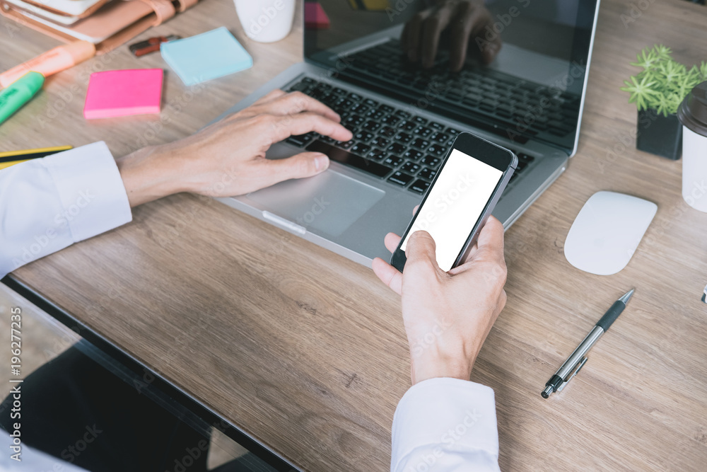 Poster businessman relaxing while using smartphone blank screen for graphics display montage. over the shou