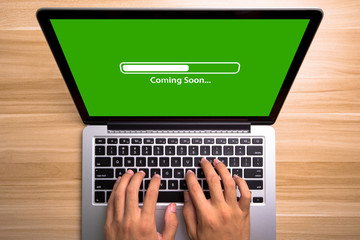 Coming soon Concept Laptop Screen With Typing Hands On Keyboard
