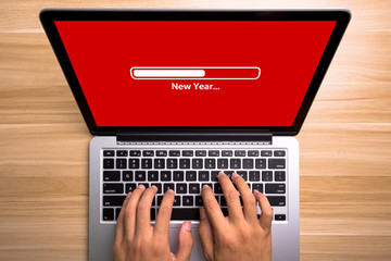 New Year Concept Laptop Screen With Typing Hands On Keyboard