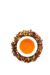 Rooibos tea blend with aromatic spices, white background 