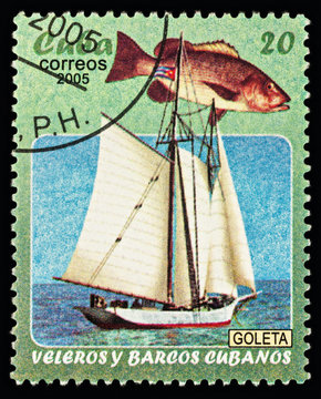 Schooner and fish on postage stamp