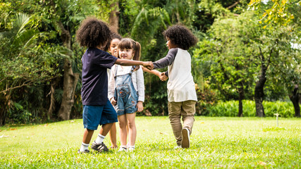 Fototapeta premium Group of children playing together in the park