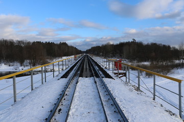 railway in winter. Rails and sleepers - a road for locomotives and electric locomotive covered with...