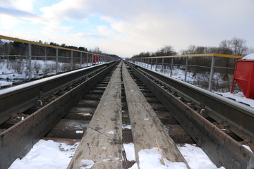 railway in winter. Rails and sleepers - a road for locomotives and electric locomotive covered with...