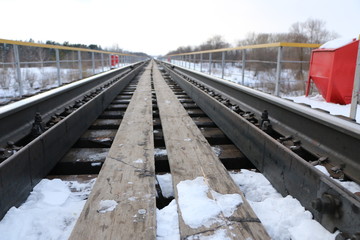 railway in winter. Rails and sleepers - a road for locomotives and electric locomotive covered with...